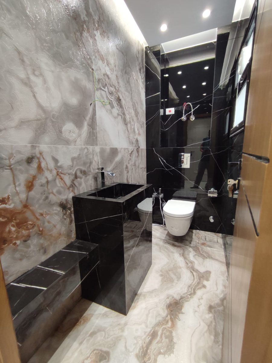 Marble bathroom with black stone basin